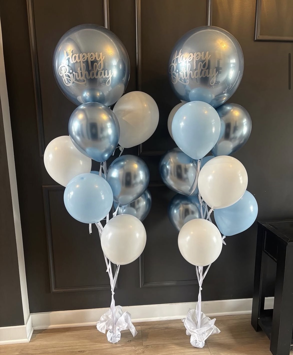 Two coordinated blue, silver and white helium birthday balloon bouquets