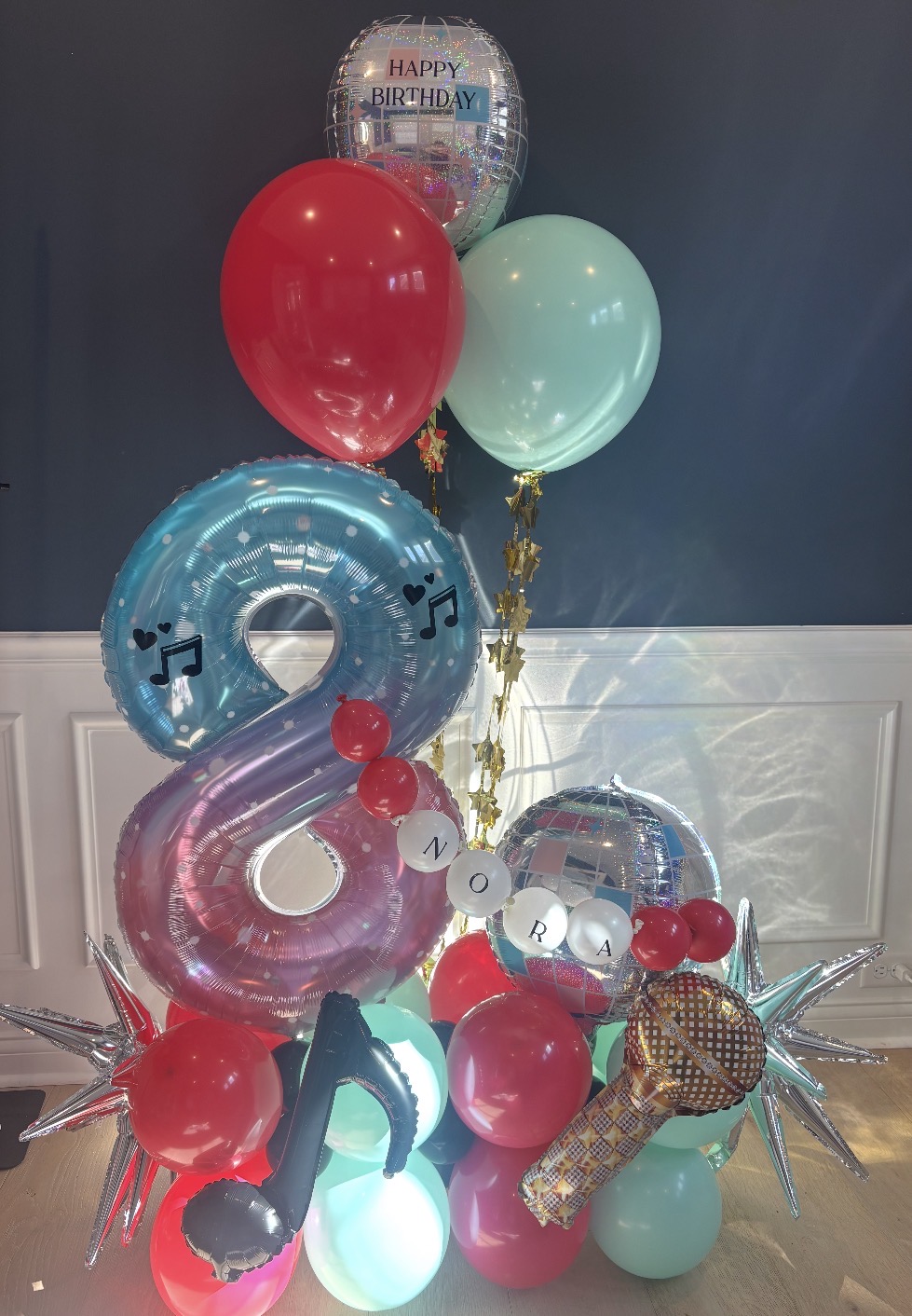 Pink and blue number eight themed birthday balloon stack with disco, music and microphone foil details